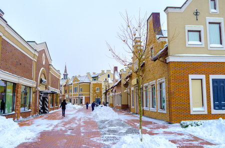 KIEV, UKRAINE - NOVEMBER 11, 2016: The snowy street in Dutch style shopping neighborhood with the gambrel roofs and curved eaves along the house, on November 11 in Kiev.のeditorial素材
