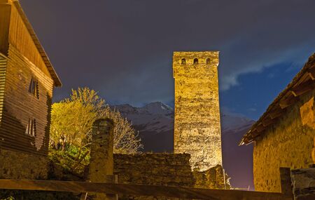 The bright Svan tower in Mestia with the dark night sky and mountains on the background, Upper...