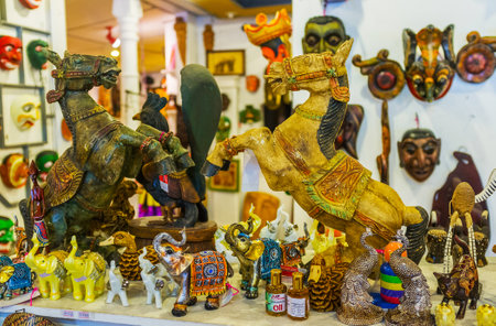 AMBALANGODA, SRI LANKA - DECEMBER 5, 2016: The wooden rearing horses, tiny elephants, peacocks and other handmade souvenirs in the mask store, on December 5 in Ambalangoda.のeditorial素材