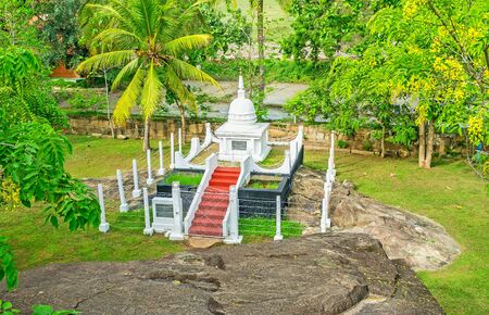 The view on the white Stupa, surrounded by trees, from the sacred Rock of Isurumuniya Temple, Anuradhapura, Sri Lanka.の写真素材