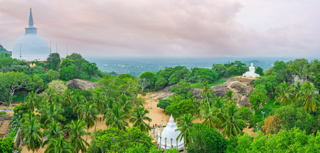 Aradhana Gala Rock overlooks the plain at the top of Mahinda's Hill with Maha Seya Stupa, Ambasthala Stupa in garden and Buddha Statue from the right, Mihintale, Sri Lanka.のeditorial素材