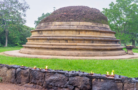 The worshipers brought the oil lamps and lit them at the ruins of Katu Seya Stupa, Mihintale, Sri Lanka.のeditorial素材