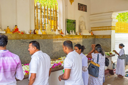 ANURADHAPURA, SRI LANKA - NOVEMBER 26, 2016: The pilgrims brought lotus flowers to the altar of Bodhi Tree Temple, on November 26 in Anuradhapura.のeditorial素材