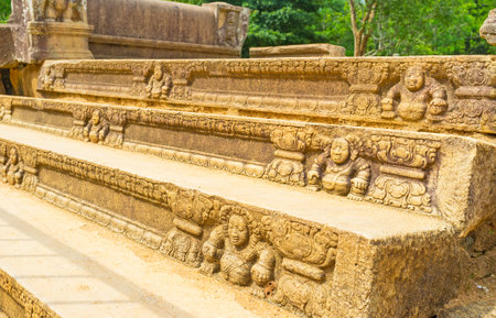 The stairs of the ruined Mahasena Palace decorated with the reliefs of dwarves, surrounded by fine patterns, Anuradhapura, Sri Lanka.のeditorial素材