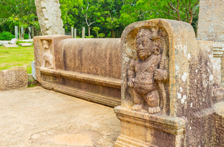The preserved parts of the wall at archaeological site of Mahasena Palace decorated with the sculptures of traditional dwarf and lion, Anuradhapura, Sri Lanka.のeditorial素材