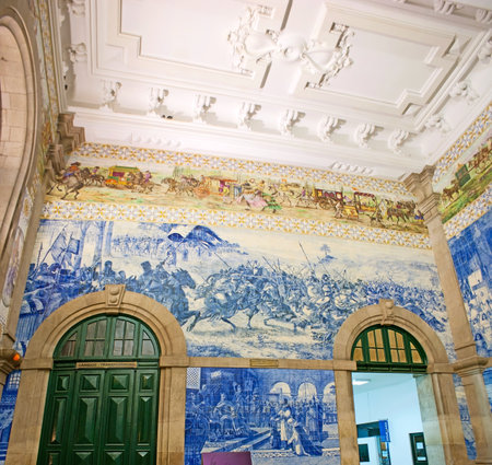 PORTO, PORTUGAL - APRIL 29, 2012: The vestibule of Sao Bento Railway Station decorated with tiled panels, covered with azulejos, depicting historic events - Battle of Valdeves and meeting of knight Egas Moniz, on April 29 in Porto.のeditorial素材