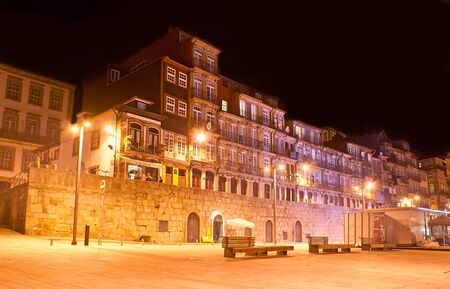 PORTO, PORTUGAL - APRIL 29, 2012: The evening Cais da Estiva embankment with old residential houses, small cafes and banches, on April 29 in Porto.のeditorial素材