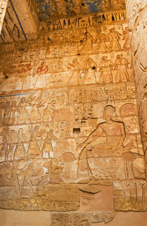 The ancient relief depicts the Pharaoh and his  subjects, bringing him riches, Habu Temple, Luxor, Egypt.のeditorial素材