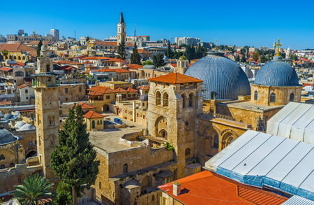 The grey domes and bell tower of the Church of the Holy Sepulchre and the slender minaret of the...