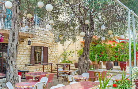 The summer terrace of the restaurant in German Colony decorated with interesting lanterns and lights, Haifa, Israel.の写真素材