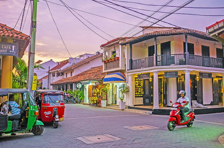 GALLE, SRI LANKA - DECEMBER 3, 2016: The tuk tuks and mopeds are most popular and comfortable types of transport in the narrow streets of walled town, on December 3 in Galle.のeditorial素材
