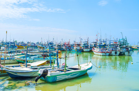 MIRISSA, SRI LANKA - DECEMBER 3, 2017: In midday the fishing trawlers and boats are in port, moored at the shore or tilted on each other, on December 3 in Mirissa, Sri Lanka.のeditorial素材