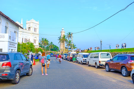 GALLE, SRI LANKA - DECEMBER 3, 2016: The tourists walk along the Rampart Street to its main landmarks - Meera Mosque and the old lighthouse, on December 3 in Galle.のeditorial素材