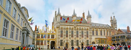 BRUGES, BELGIUM - MAY 26, 2011: Panorama of main landmarks at the crowded Burg Square - the splendid Renaissance Palace of Liberty, Gothic City Hall and the Romanesque Basilica of Holy Blood, on May 26 in Bruges.のeditorial素材