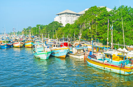 The Kothalawala bridge overlooks the Negombo lagoon with numerous colorful fishing ships, moored here, Sri Lanka.のeditorial素材