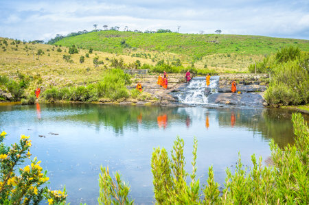 HORTON PLAINS PARK, SRI LANKA - NOVEMBER 30, 2016: The buddhist monks rest and play in small waterfall, on November 30 in Horton Plains Parkのeditorial素材