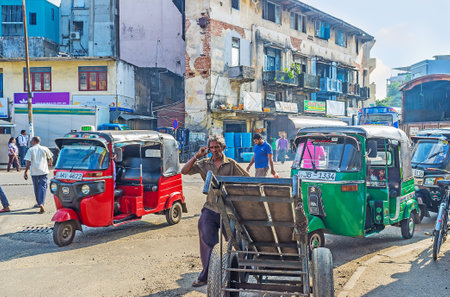 COLOMBO, SRI LANKA - DECEMBER 6, 2016: The old trolley parked at the roadside of the former Wolfendhal street with the battered Abdeen Building on background, on December 6 in Colombo.のeditorial素材