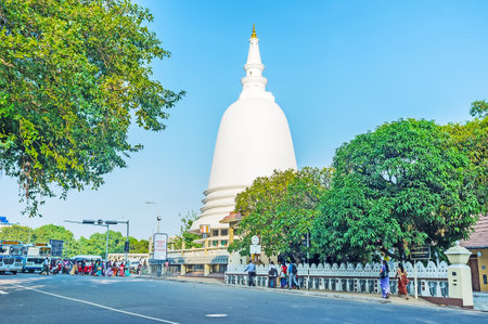 COLOMBO, SRI LANKA - DECEMBER 6, 2016: The tall white stupa of Sri Sambuddhaloka Viharaya Temple, located on the junction of Lotus road in Fort district, on December 6 in Colombo.のeditorial素材