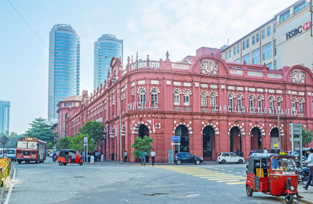 COLOMBO, SRI LANKA - DECEMBER 6, 2016: The red building of Cargills and Miller in York Street with the skyscrapers on the background, on December 6 in Colombo.のeditorial素材