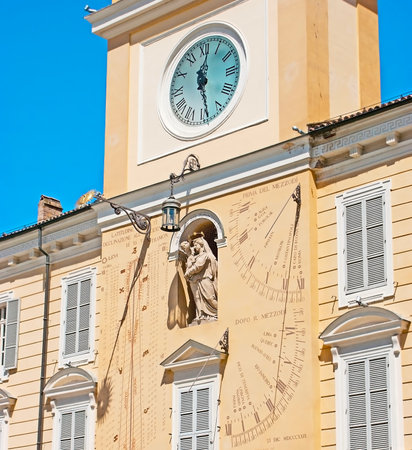 The clock tower of the Governor Palace in Parma decorated with the stone sculpture of Virgin Mary, surrounded by historic astronomical clock, sundials and analemmas (sun calendars), Italy.のeditorial素材