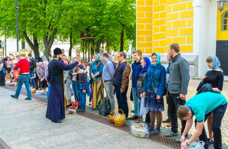 KIEV, UKRAINE - MAY 01, 2016: People bring food to the church on Easter for sprinkling of holy water, on May 1, in Kiev.のeditorial素材