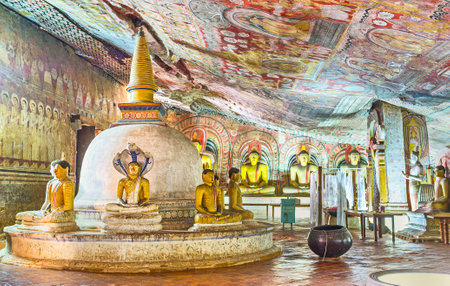 DAMBULLA, SRI LANKA - NOVEMBER 27, 2016: The interior of the Maharaja Lena Cave (Great Kings) od Dambulla Viharaya with old stupa, painted walls and numerous sculptures, on November 27 in Dambulla.のeditorial素材