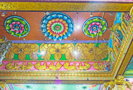 MATALE, SRI LANKA - NOVEMBER 27, 2016: The ceiling in Muthumariamman Kovil - Tamil Hindu Temple decorated with rosettes of carved lotus flowers, painted patterns and reliefs, on November 27 in Matale.のeditorial素材