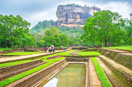 SIGIRIYA, SRI LANKA - NOVEMBER 27, 2016: The huge Sigiriya Rock behind the small reservoir, located in Royal Gardens, on November 27 in Sigiriya.のeditorial素材