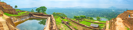 Panorama of the Upper Palace of Sigiriya with the cistern, full of water, ancient ruins and the green plain on the background, Sigiriya, Sri Lanka.の写真素材