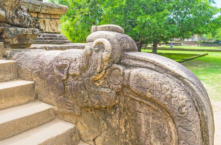 The carved dragon decorates the ancient rails of the building of Palace Complex of King Parakramabahu, Polonnaruwa, Sri Lanka.のeditorial素材