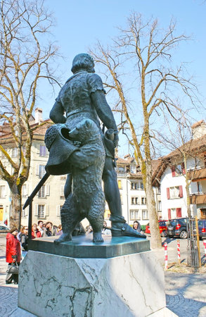 BERNE, SWITZERLAND - MARCH 3, 2011: The bear, that is the city symbol, stands behind the founder of Berne, at Zahringer Denkmal Monument, on March 3 in Berne.のeditorial素材