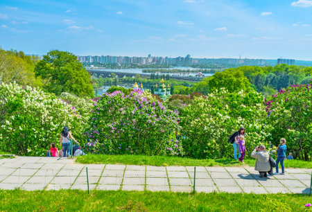 KIEV, UKRAINE - MAY 2, 2016: Locals climb to the top of the Botanical Garden hills to enjoy great view on beautiful cityscape, on May 2, in Kievのeditorial素材