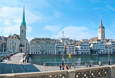 ZURICH, SWITZERLAND - MARCH 20, 2011: The view on Stadthausquai embankment of Limmat river with the notable city landmarks - the Fraumunster Kirche and St Peterskirche, seen behind the houses, on March 20 in Zurich.のeditorial素材