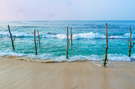 Stilt fishing was historically traditional for Sri Lankans, today it's preserved as the tourist attraction, Ahangama.の写真素材
