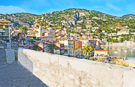 VILLEFRANCHE-SUR-MER, FRANCE - FEBRUARY 22, 2012: The view on the old town, located in valley and Darse harbor, surrounded by Alps,  on February 22 in Villefranche-sur-Mer.のeditorial素材