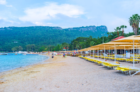 KEMER, TURKEY - MAY 5, 2017: Dakapo beach is the perfect place for rest, the golden sandy seashore surrounded by lush pine garden with numerous cafes and bars, on May 5 in Kemer.のeditorial素材