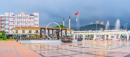 KEMER, TURKEY - MAY 5, 2017: Ataturk monument, surrounded by fountains and wth the tourist bazaar on background, on May 5 in Kemer.のeditorial素材