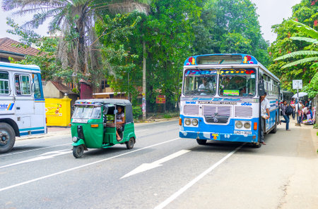 PERADENIYA, SRI LANKA - NOVEMBER 28, 2016: The tuk tuks and public buses are the most popular transport in country, on November 28 in Peradeniya.のeditorial素材