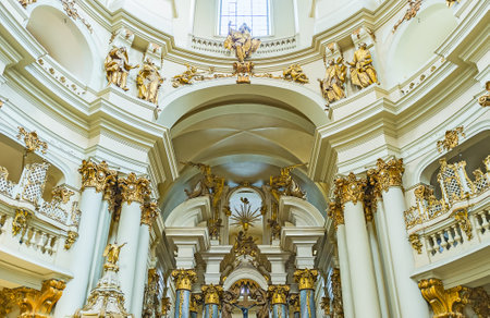 LVOV, UKRAINE - MAY 16, 2017: The Baroque decors of Dominican church, the golden sculptures and reliefs on white background of walls, arches and columns, on May 16 in Lvov.のeditorial素材