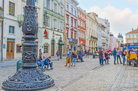 LVOV, UKRAINE - MAY 16, 2017: The cast iron base of the streetlight in Market Square covered with floral reliefs, on May 16 in Lvov.のeditorial素材