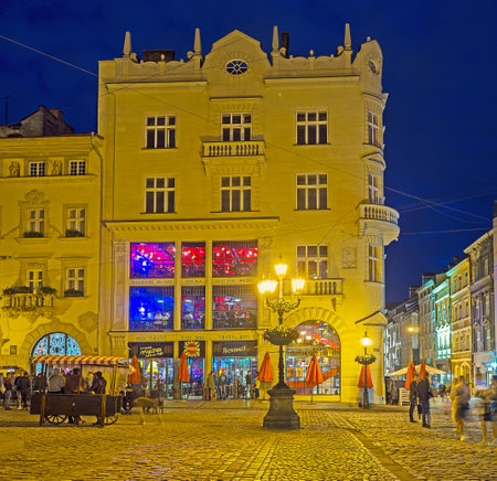 LVOV, UKRAINE - MAY 16, 2017: The Old Town is the best place for the evening walks, Market Square (Ploshcha Rynok) changes its look in bright illumination, on May 16 in Lvov.のeditorial素材