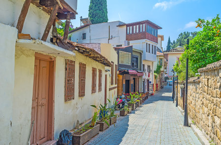 The narrow street in historic Kaleici neighborhood with outdoor cafes and souvenir shops, Antalya, Turkey.のeditorial素材