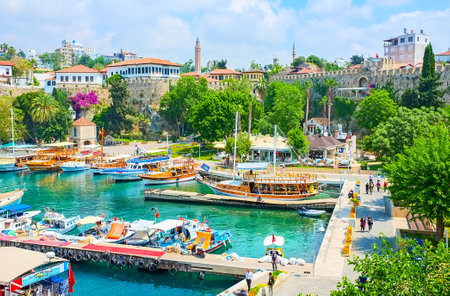 ANTALYA, TURKEY - MAY 6, 2017: The old marina is the best place for the pleasant walk, watching the moored ships, preserved city walls, scenic mansions and relax in shady park, on May 6 in Antalya.のeditorial素材