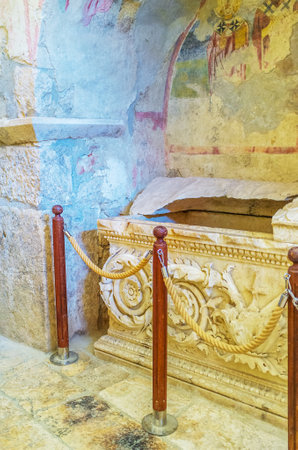 DEMRE, TURKEY - MAY 7, 2017: Praying and touching the stone sarcophagus of St Nicholas is best way to ask for blessing, on May 7, in Demre.のeditorial素材