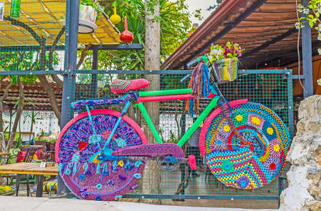 ANTALYA, TURKEY - MAY 6, 2017: The bicycle in knitted cover is the perfect street decoration, also serving as the flower pot, on May 6 in Antalya.の写真素材