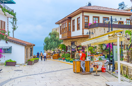 ANTALYA, TURKEY - MAY 6, 2017: The old street of Kaleici leads to the edge of the cliff with the scenic view on the sea behind the Ottoman houses and tourist cafes, on May 6 in Antalya.のeditorial素材