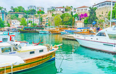 ANTALYA, TURKEY - MAY 6, 2017: The old harbor with ships and yachts, surrounded by medieval ramparts and the Ottoman houses behind them, on May 6 in Antalya.のeditorial素材