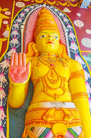 PAMUNUWA, SRI LANKA - NOVEMBER 29, 2016: The colorful statue of Lord Buddha in Pamunuwa Buddhist Temple shows abhayamudra - the gesture of fearlessness, on November 29 in Pamunuwa.のeditorial素材