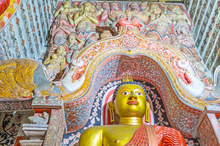 UDUNUWARA, SRI LANKA - NOVEMBER 29, 2016: The Dragon's Arch in Lankathilaka Vihara is richly decorated  with painted patterns and relief sculptures of Hindu deities, on November 29 in Udunuwara.のeditorial素材