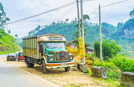 PUSSELAWA, SRI LANKA - NOVEMBER 29, 2016: The retro Tata truck parked at the road with the scenic mountain landscape on background, on November 29 in Pusselawa.のeditorial素材